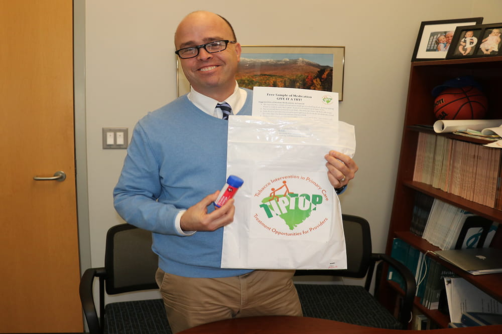 a man holds smoking cessation goody bag